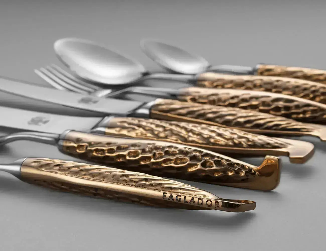 "A collection of bronze handled flatware with sculptural detail by Eaglador".
