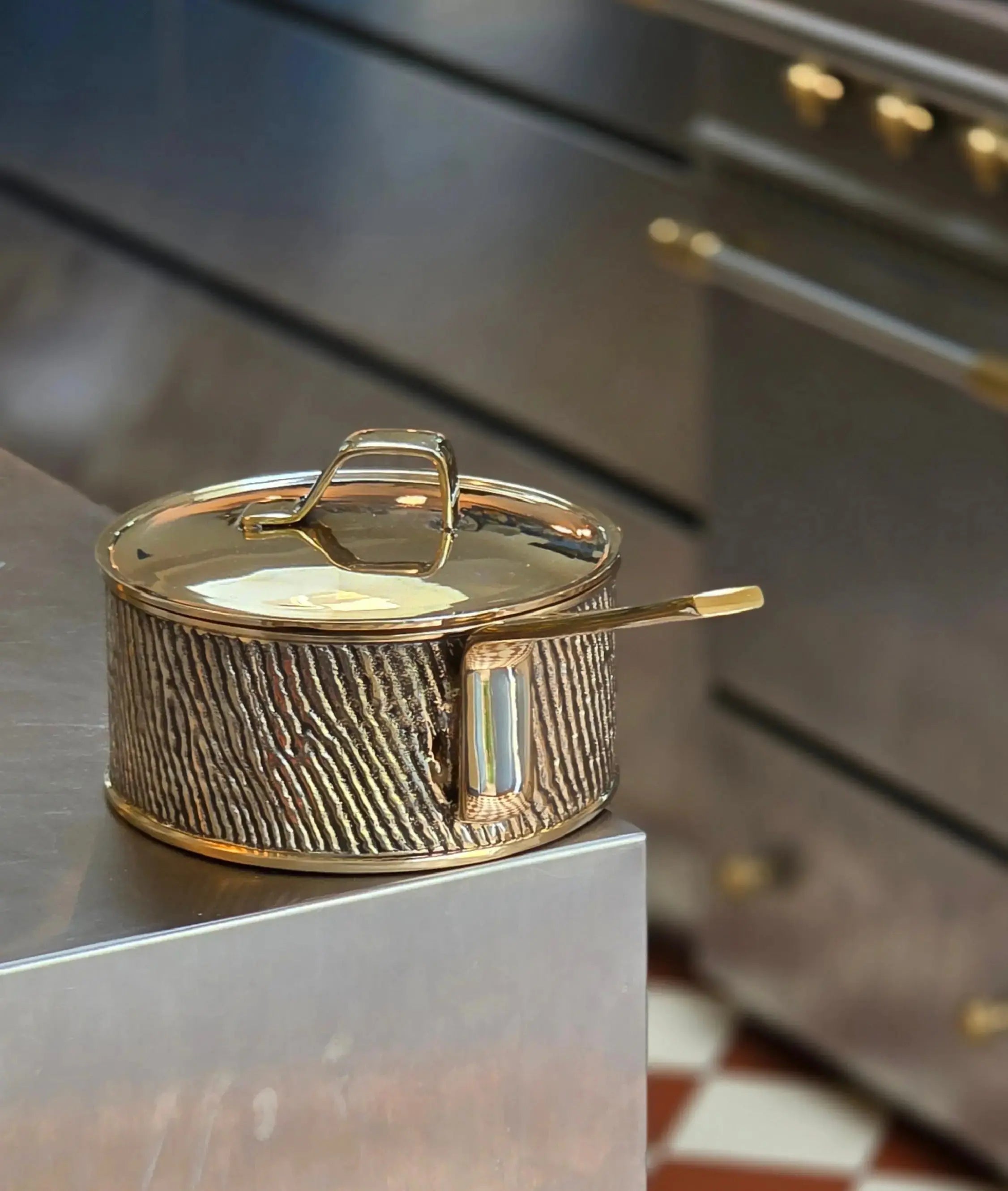 Natural patina on luxury PFAS-free uncoated Kansa bronze saucepan seen in a modern kitchen