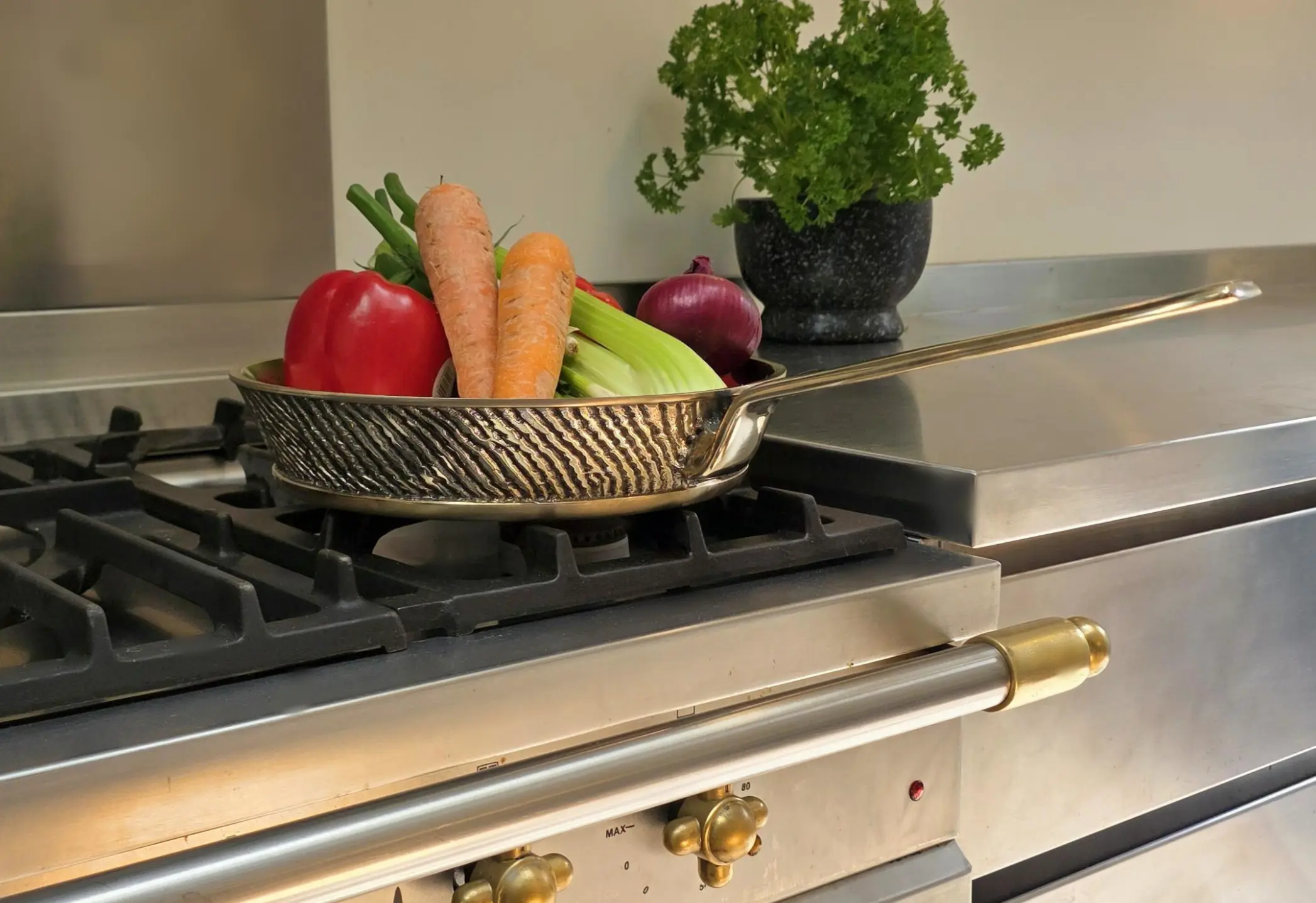 "Handcrafted heavy gauge Kansa bronze frying pan on premium stovetop with fresh ingredients – Eaglador heirloom cookware UK".