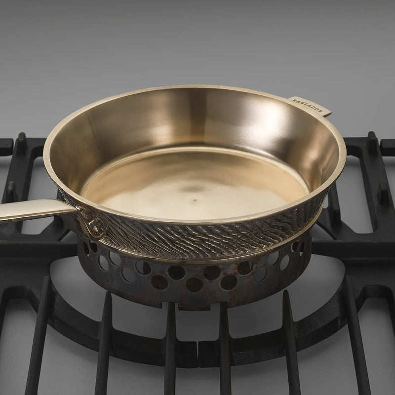 Eaglador uncoated kansa bronze frying pan seen on a stovetop