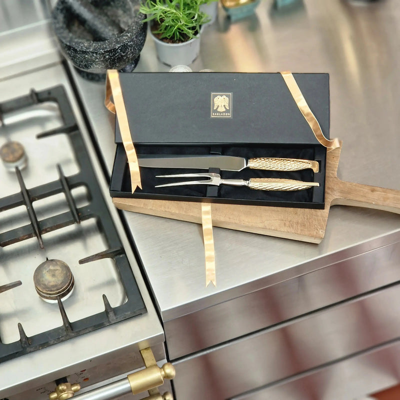 "Eaglador bronze carving set seen in a gift box in a kitchen setting - luxury handmade cutlery UK".