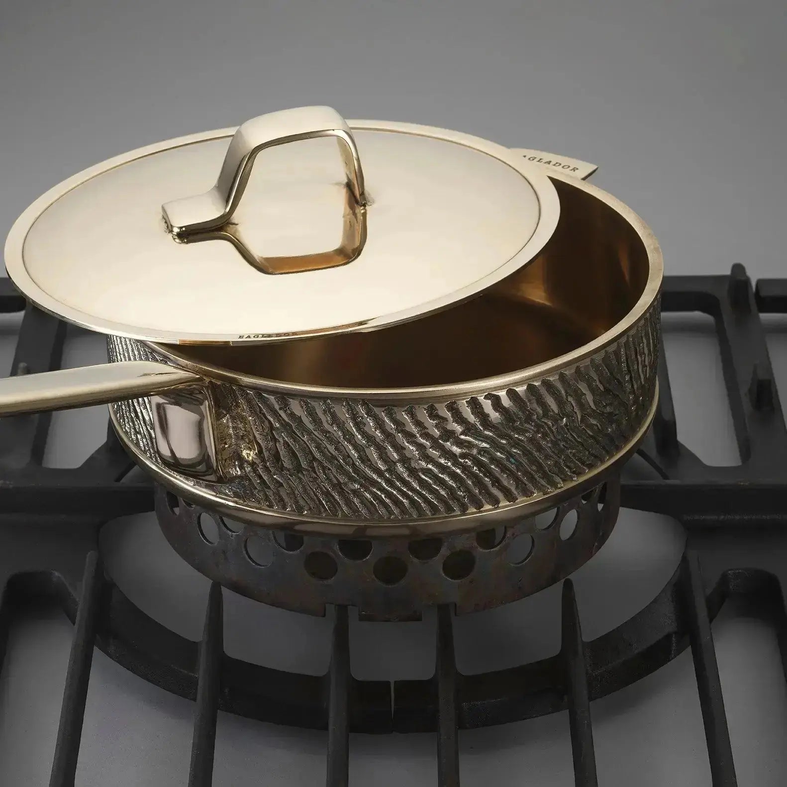 Luxury PFAS-free uncoated Kansa bronze sauté pan in use on stove