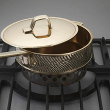 Luxury PFAS-free uncoated Kansa bronze sauté pan in use on stove