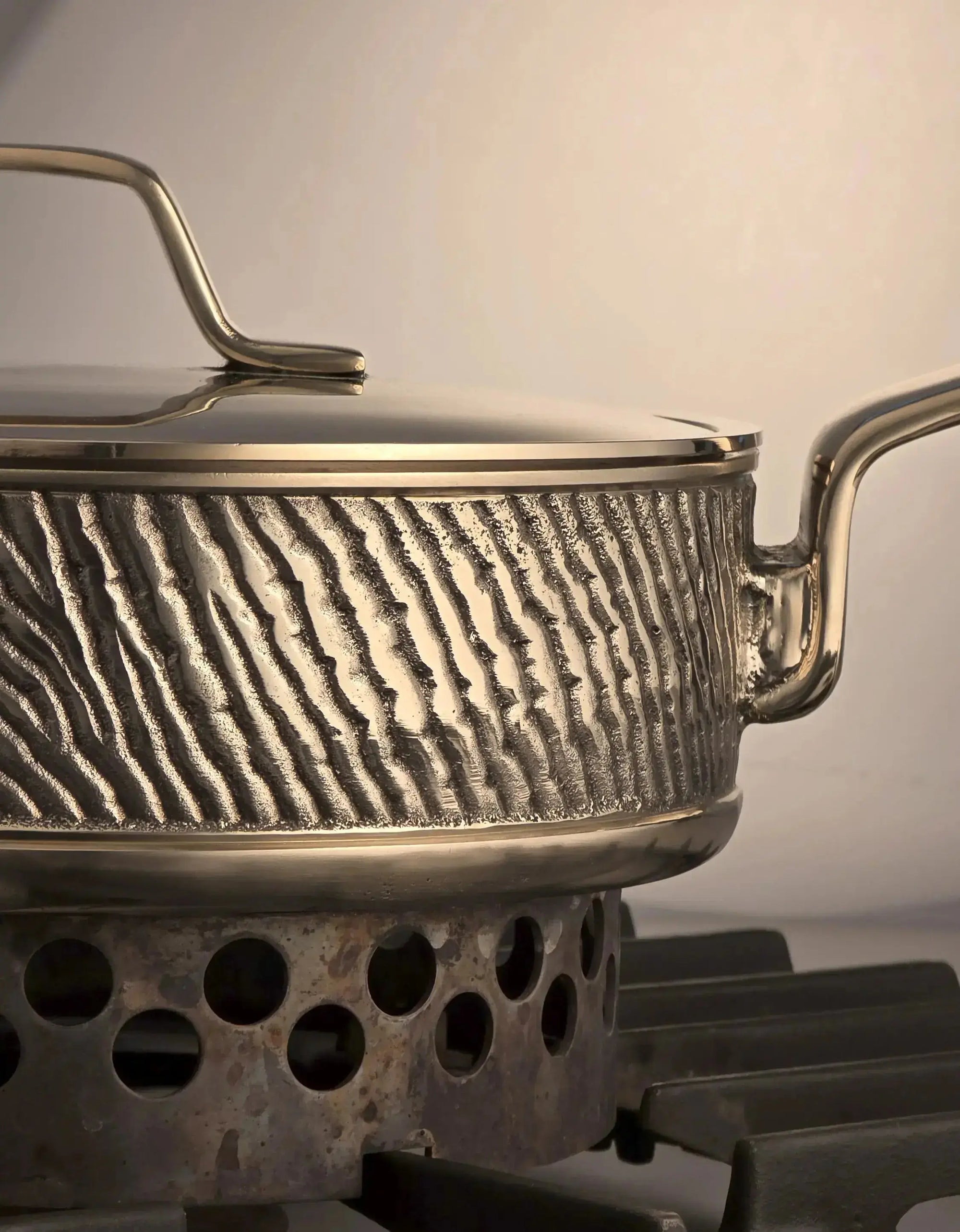 Close-up of luxury PFAS-free uncoated Kansa bronze sauté pan with welded handle